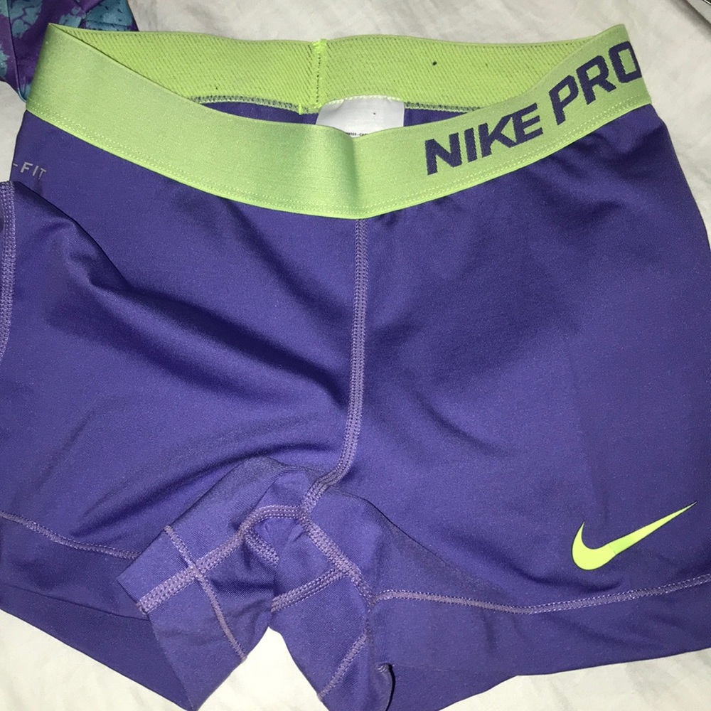 Purple and green Nike Pros